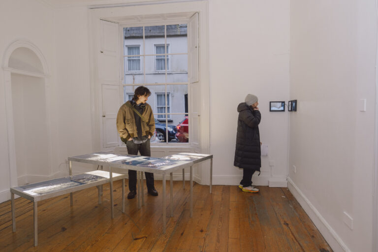 Image of people at draft fissure exhibition at the galway arts centre gallery.